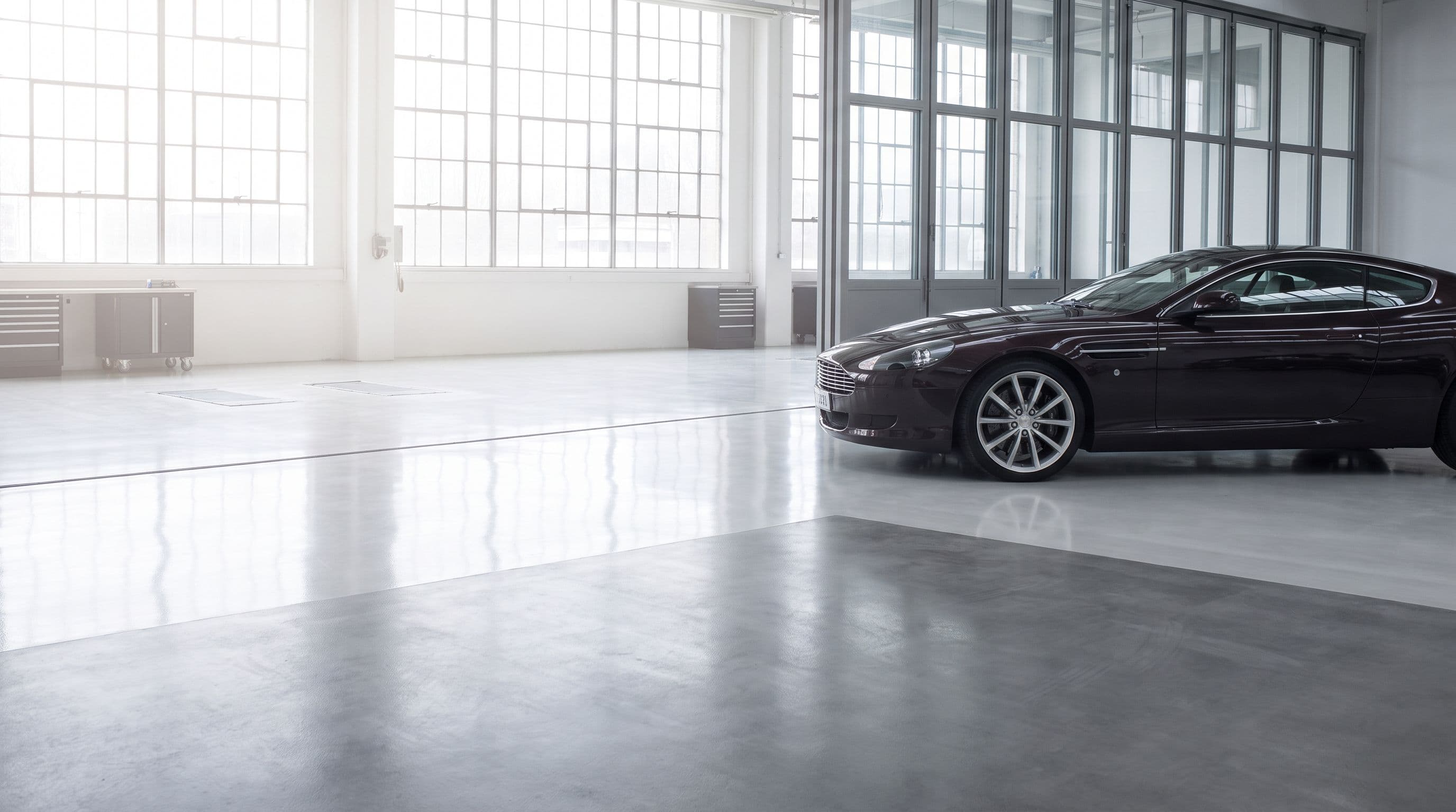A car in a bright, misty service bay at dawn.